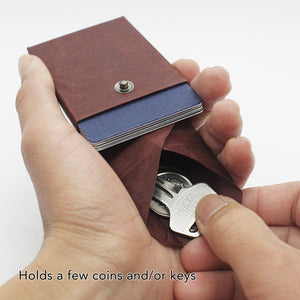 Kamino card wallet holds a few coins and keys.